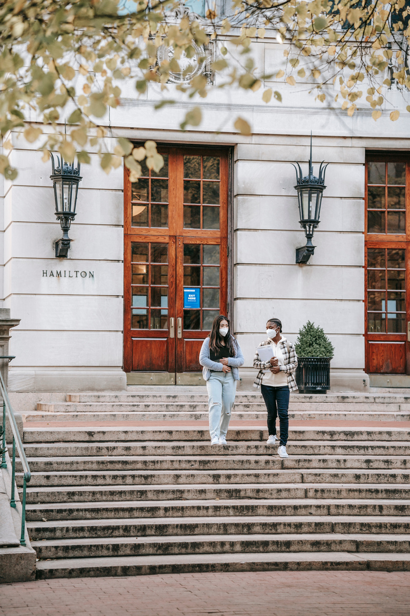 Diverse students walking downstairs from university